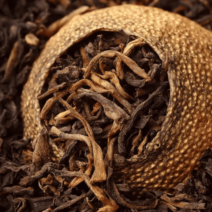 close-up of dried xiaoqinggan green mandarin stuffed with aged puerh tea leaves