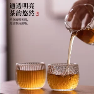 Heat-resistant transparent glass tea cup with hammered texture, suitable for home use as a Kung Fu tea cup.